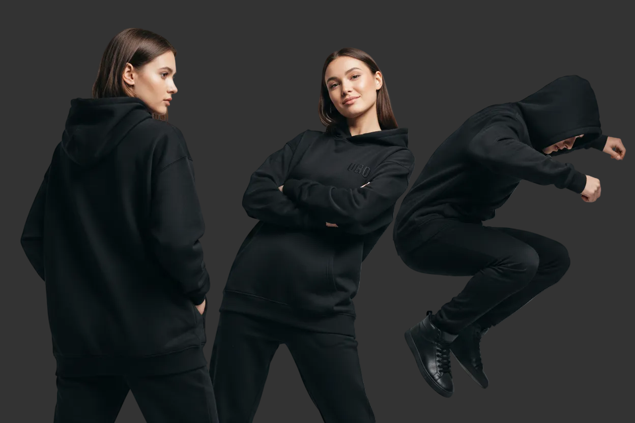 3 FEMALE AND MALE MODELS WEARING BLACK HOODIES DOING POSE